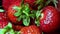 Rotation of red ripe strawberries close-up