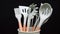 Rotation of silicone or rubber kitchen utensils on black background. Tools for cooking