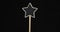 Rotation of the star-shaped signpost. Wooden post with copy space in a frame on black background.