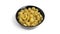 Rotelle pasta in black bowl isolated on white background.