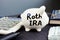 Roth IRA written on a piggy bank. Retirement plan.