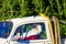 ROTHENBACH, GERMANY - OCTOBER 10. 2018: View on Santa Claus sitting in white VW beetle classic car with fir Christmas tree on roof