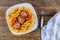 Rotini pasta with meatballs in tomato sauce and olives in bowl