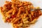 Rotini in a sausage and pasta sauce on a plate