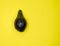 Rotten avacado on a yellow background. Creative food composition Flat lay