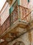 Rotten balcony with rusty balustrade