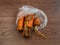 Rotten carrots in bag on brown surface