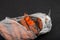 Rotten carrots in plastic bag. Improper food storage. Ugly moldy vegetables. Concept - reduction of organic waste. Dark textured