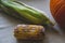 Rotten corn on the table next to the pumpkin