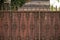 Rotten fence surrounding a house in the city