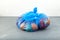 Rotten fruits pomegranate, persimmon, orange in blue garbage bag. Organic food waste. Imperfect storage vegetables and fruits