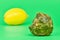 Rotten lemon and fresh lemon compare, green background