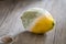 Rotten lemon with mould on wooden background