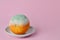 Rotten orange. Rotten moldy orange in a plate on pink background. A photo of the growing mold. Food contamination, bad spoiled