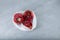 Rotten spoiled pomegranate fruits in plastic bag. Ugly moldy fruit. Top view, selective focus. Improper food storage. Concept -