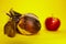 Rotten and spoiled quince on yellow surface and red blurred apple . It has become unfit for consumption.