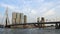 ROTTERDAM, NETHERLANDS - 28 AUG 2018. Small and Fast Yellow speedboat Floats under Erasmus bridge over Nieuwe Maas.