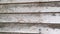 Rotting planks texture wood wall of an abandoned house.