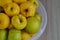 Rotting yellow apples, shriveled apples that have been sitting in a bowl for a long time