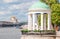 The rotunda on Pushkinskaya embankment in Gorky Park. In the background a view of the Crimean bridge over