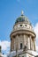 Rotunda style building with green brass dome and gold statue on top