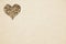 Rough beige painted wall with wooden heart