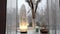 Rough big selenite crystal tower lamp illuminated on home window sill, spiritual home decor accent.