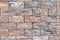 Rough bricks fence texture. Stone multicolored wall background