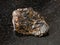 Rough Cassiterite Tin ore stone on black