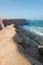 Rough coast line with towering cliffs and wild ocean in Angola