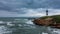 Rough coastline with lighthouse time lapse under the cloudscape