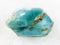 rough crystal of blue apatite gemstone on white