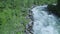 Rough flowing mountain river, over water video, quadcopter aerial view, wildlife beauty.