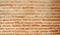 Rough horizontal line of natural lighter brown color clay brick in mortar concrete structure wall background