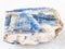 rough kyanite stone on white marble