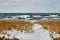 Rough lake and snow covered winter shoreline