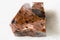 rough Mahogany Obsidian rock on white marble