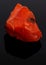 Rough red carnelian rock isolated on black
