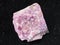 rough rhodonite stone on dark background