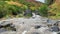 Rough river with mountain water. Water pours over the stones.