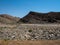 Rough rock mountain drought landscape ground of Namib desert unique geography with splitting stone and desert green plant