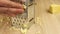 Rough rubbing cheese on a grater