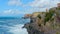 rough sea big waves crash on small port of Nervi in Genoa in Italian Riviera of liguria in beautiful sunny day