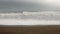 Rough sea from coastline with waves, wind and foam