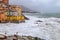 Rough sea in the village of Genoa Boccadasse with colorful houses, Italy.