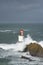 Rough sea and waves over the lighthouse of Pasaia, Euskadi