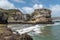 Rough seas against a cliff housing gannet colonies in Muriwai Beach