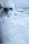 Rough seas crashing against Brighton sea wall with cliffs behind