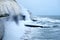 Rough seas crashing against Brighton sea wall with cliffs behind