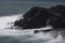 Rough seas with a slow shutter image of tide hitting the volcanic lava coastline of Sao Miguel